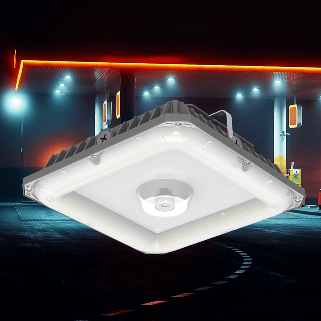 AEH5 LED Gas Station Canopy Light Square Gray Aluminum Housing with Central Microwave Motion Sensor Installed at Night Petrol Station Showing Bright White Illumination Under Red Neon Canopy
