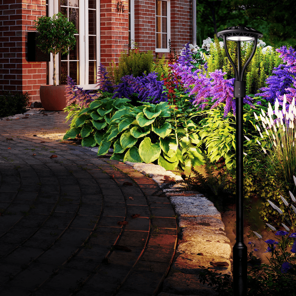 AEH2 LED Garden Post Light 100W-150W Dusk-to-Dawn Auto On-Off Installed Along Brick House Garden Pathway with Colorful Flower Bed at Dusk

