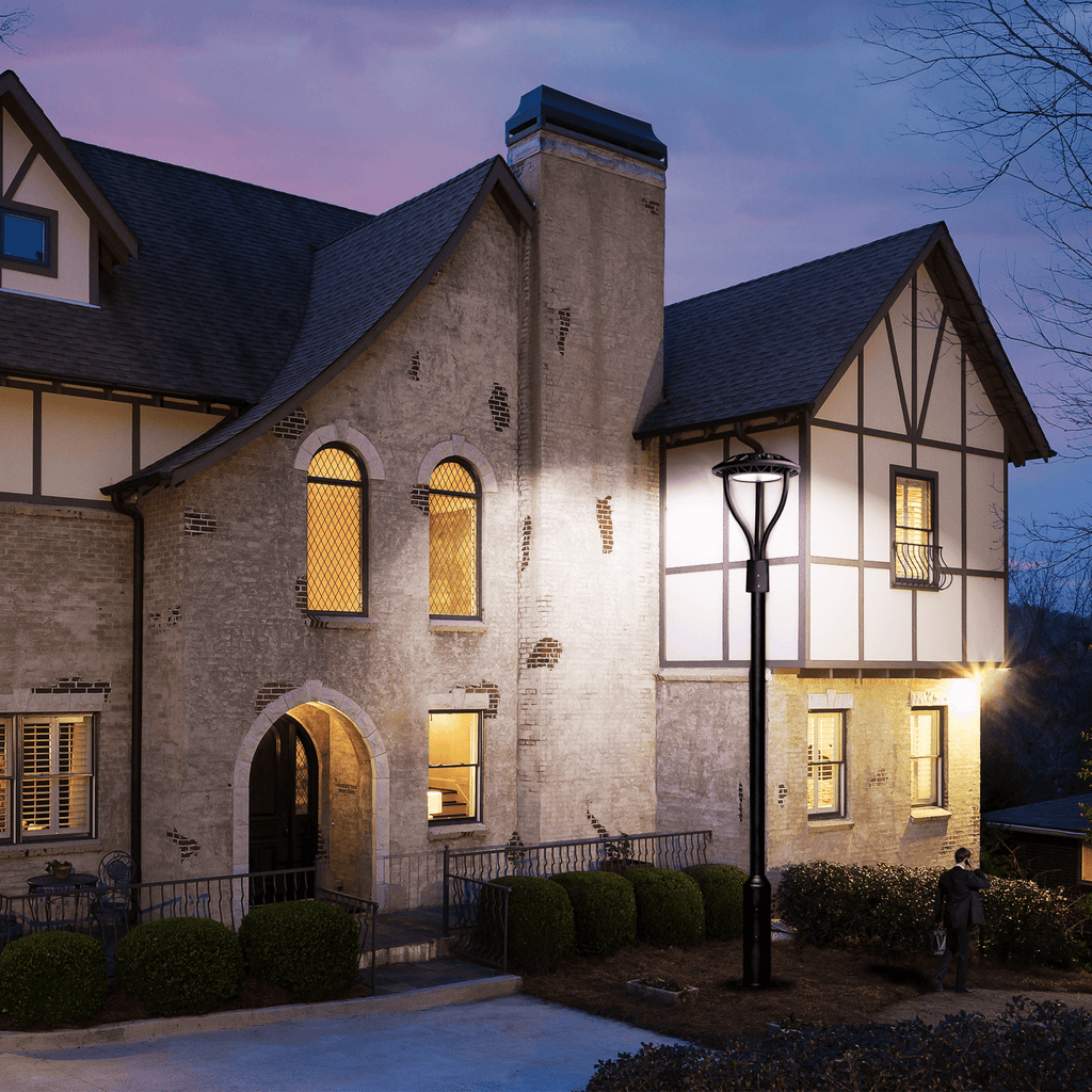 AEH2 LED Garden Post Light Installed at Tudor-Style Mansion Entrance at Dusk Providing Bright White Illumination for Residential Driveway and Facade Lighting

