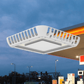 AEH6 LED Gas Station Canopy Light Front Isometric View Suspended Against Dusk Gas Station Canopy Background Showing Square White Aluminum Frame with Perimeter Louvered Heat Sink Fins and Central Frosted PC Diffuser Panel for Petrol Station Ceiling Lighting
